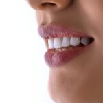 a close up of a woman's mouth with white teeth