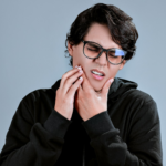 woman in black framed eyeglasses and black long sleeve shirt